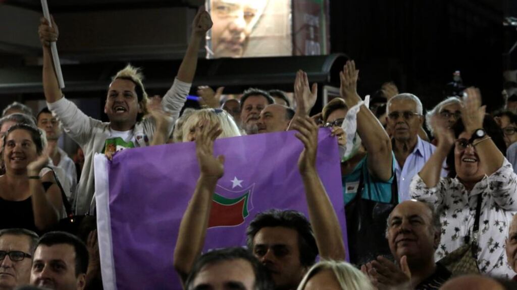 Supporters of the leftist Syriza party celebrate after the announcement of exit poll results in Athens. Photograph: Yannis Kolesidis/EPA