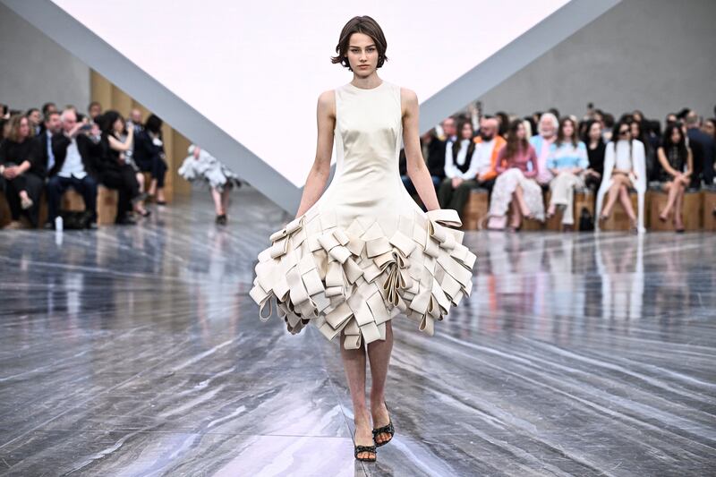 That archive was the starting point of the collection: twisted, folded, pleated and looped garments that resulted in silhouettes that veered from shapely hourglass dresses to hooped or bouffant skirts. Photograph: JULIEN DE ROSA/AFP via Getty Images      