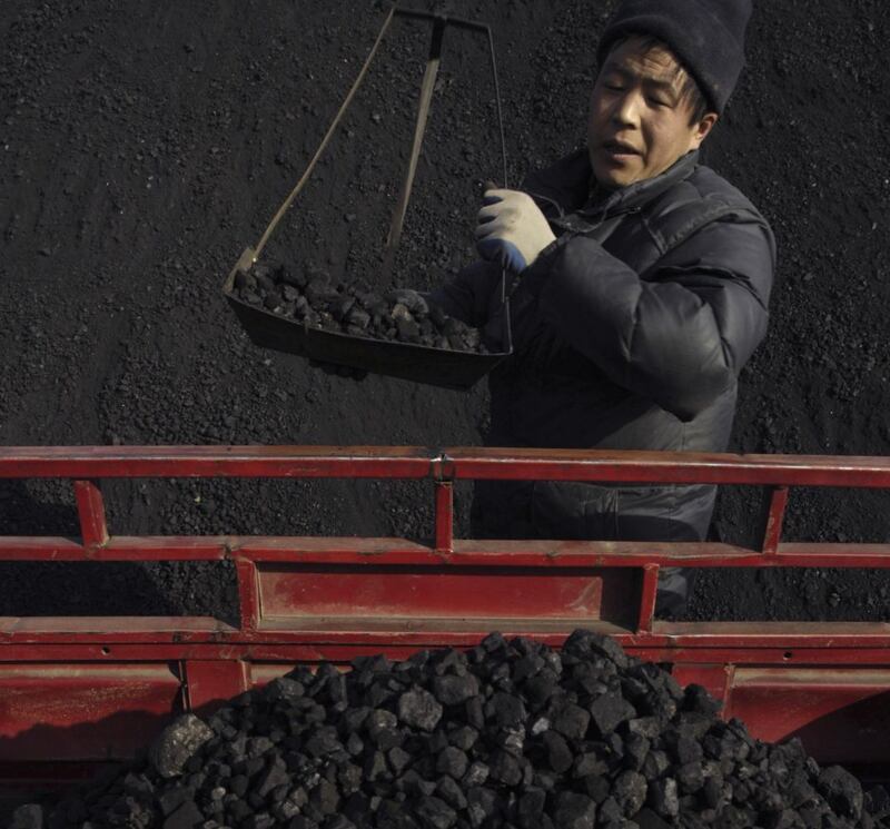 A labourer works in a coal ball plant in Xining, China. Photograph: Reuters