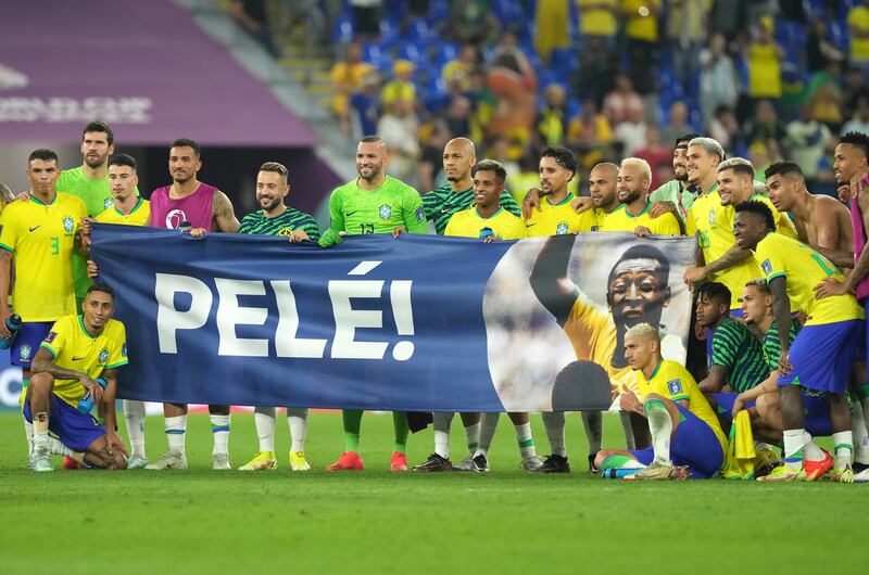 Brazil players bring a Pelé banner on to the pitch following the win over South Korea. Photograph: Martin Rickett/PA Wire