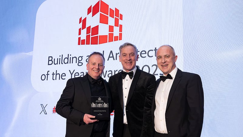 Barry Hennessy, director of business development & marketing of Walls Construction, presents Architectural practice of the year to Finghin Curraoin and Peter McGovern, Henry J Lyons