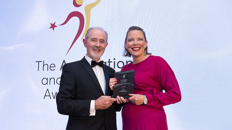 Sean Quigley, awards judge, presents the best event award to Louise Keegan, Learnovate