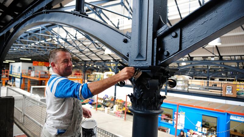 Painting of roof girders at the fruit and vegetable market on Mary’s Lane  by  Derek Douglas back in 2013. Photograph: Aidan Crawley