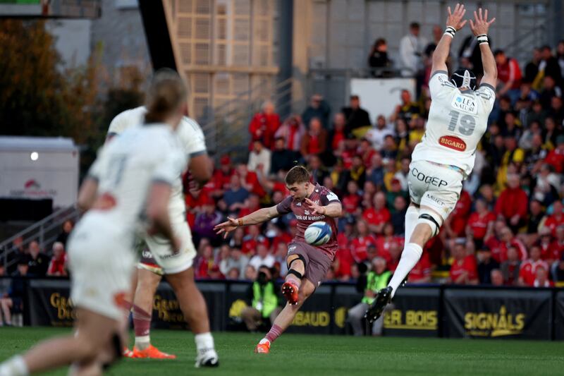 Jack Crowley scores a drop goal despite the attempt of La Rochelle's Ultan Dillane during the Champions Cup Round of 16 game at Stade Marcel Deflandre. Photograph: Romain Perrocheau/AFP via Getty Images          