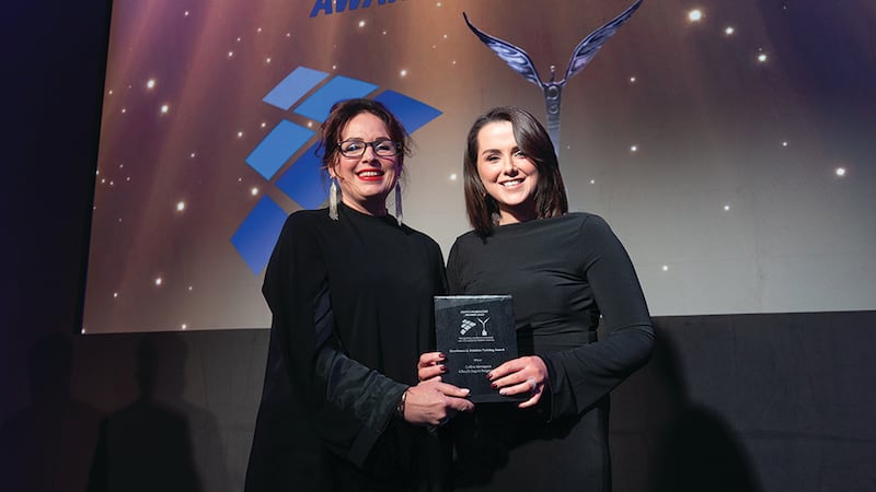 Samantha Harding, awards judge, presents the excellence in aviation training award to Niamh Johnston, Collins Aerospace