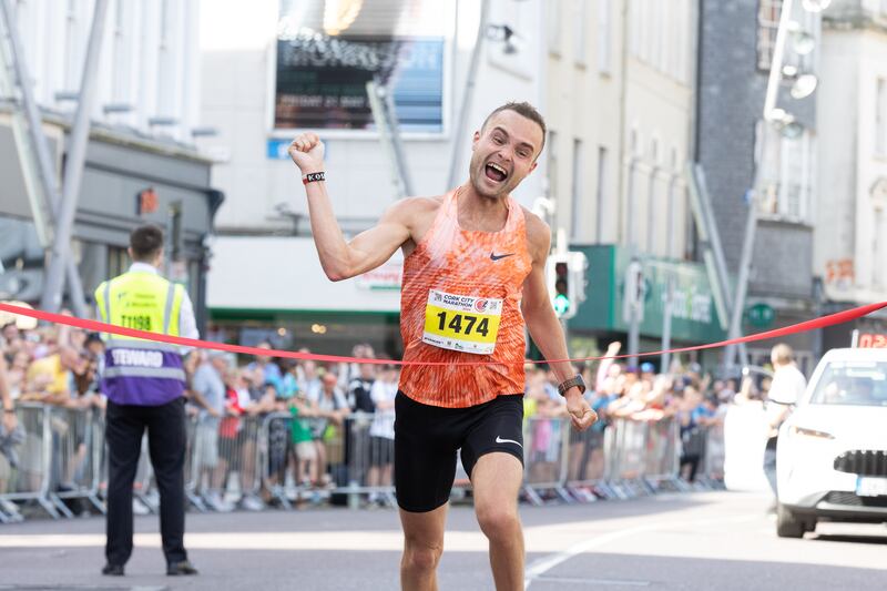 Pawel Kosek crosses the finish line as he wins the Cork City Marathon. Photograph: Darragh Kane