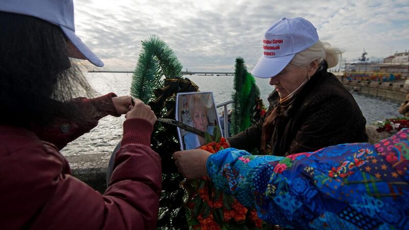 Residents of Sochi lay a wreath paying tribute to the victims of Tu-154 plane crash in the Black Sea outside Sochi. Ninety two persons were on board, including 65 members of the Alexandrov Song and Dance ensemble, eight crew members, nine Russian journalists as well as Russian civil activist, Doctor Yelizaveta Glinka (Doctor Liza). No survivors have been found. Photograph: Yevgeny Reutov/EPA