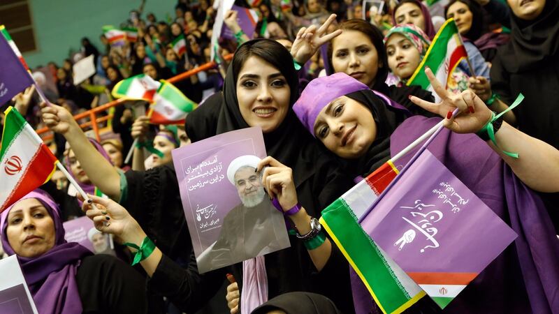 Supporters of   Iranian  president   Hassan Rouhani: he and five other candidates  are running in presidential   elections in a country where millions run  moneymaking schemes just to keep up and  youth unemployment  is at 30 per cent.  Photograph: Abedin Taherkenareh/EPA