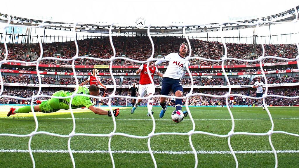 Christian Eriksen of Spurs strokes the ball into the net for the first goal during the hotly contested north London derby between Tottenham and Arsenal at the Emirates Stadium. Photograph: Getty