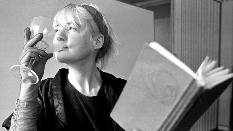 Glass half full: Evelyn Byrne performs at an event in 1989 in Dublin where women writers, artists and performers displayed and discussed their creativity. Photograph: Paddy Whelan