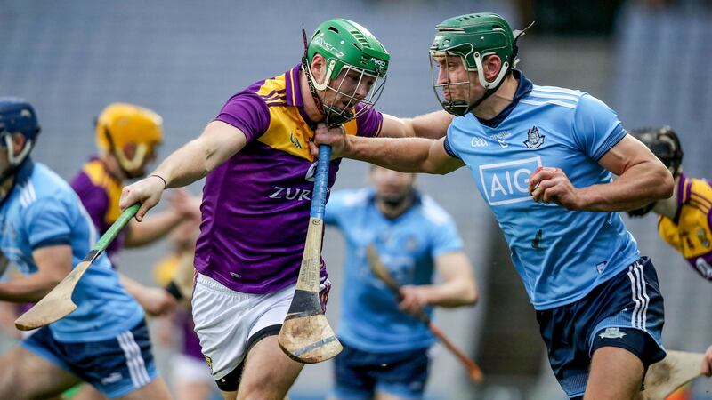 Wexford’s Matthew O’Hanlon tries to put  Chris Crummey under pressure. Photograph: Bryan Keane/Inpho