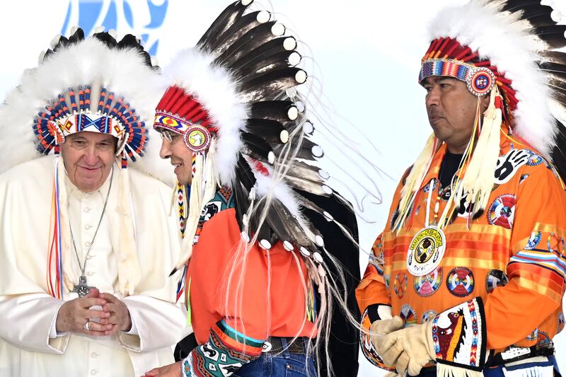2022. Pope Francis wears a headdress presented to him by Indigenous leaders at Muskwa Park in Maskwacis, Alberta, Canada, on July 25, 2022. Photograph: Patrick T. Fallon / AFP via Getty Images