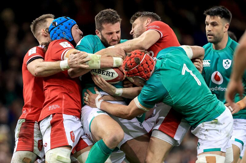 Three's a crowd: Wales found that stopping Stuart McCloskey is not a one-man job. Photograph: Dan Sheridan/Inpho 
