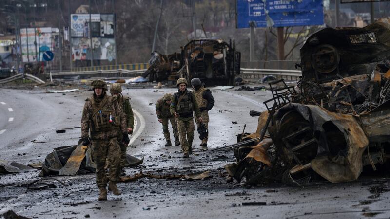 Ukrainian soldiers walk next to destroyed Russian vehicles in Bucha, Ukraine, where the mayor says 300 residents had been killed during a month-long occupation. Photograph: Rodrigo Abd/AP
