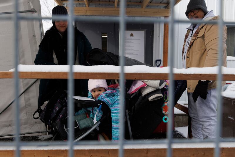 A family from Venezuela awaits processing after claiming asylum at the Roxham Road border crossing in Saint-Bernard-de-Lacolle. Photograph: Nasuna Stuart-Ulin/New York Times