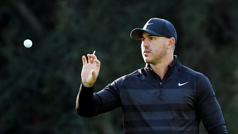 Brooks Koepka  catches a ball on the 12th green during the first round of the Genesis Invitational in Pacific Palisades, California. Photograph: Harry How/Getty Images