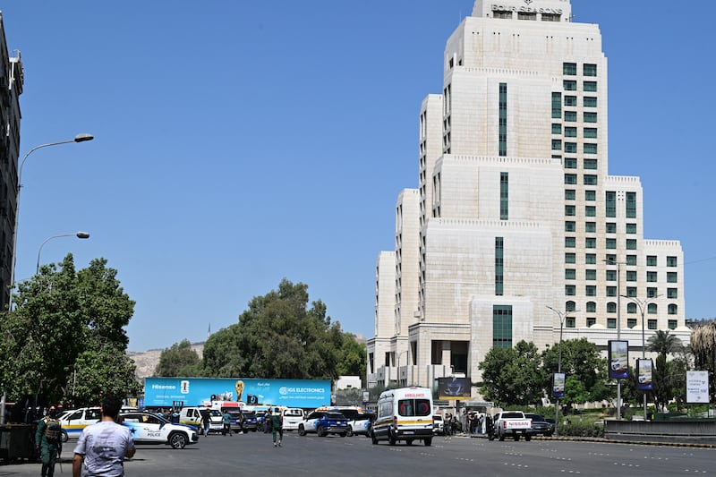 Syrian police officers and emergency personnel gather near the Four Seasons Hotel in Damascus following two explosions. Photograph: AFP via Getty Images