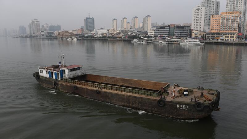 A North Korean ship passes in front of the waterfront of the Chinese border city of Dandong, in China’s northeast Liaoning province, opposite the North Korean town of Sinuiju. Photograph: Greg Baker/AFP/Getty Images