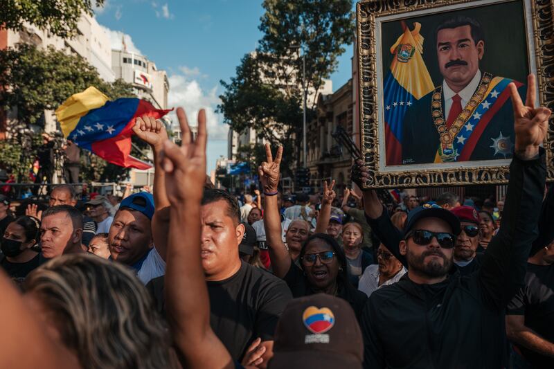 Supoprters of president Nicolás Maduro gather near Miraflores Palace in Caracas on Sunday. Photograph: The New York Times