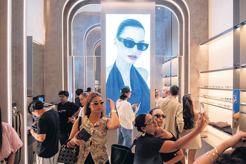 Shoppers at the opening of a new eyewear store in the Dubai Mall in Dubai, United Arab Emirates, on May 22, 2026. The city’s prosperity depends heavily on an image of stability. (Natalie Naccache/The New York Times)