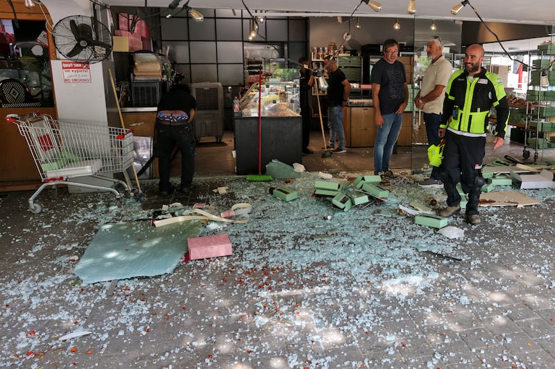 People inspect the damage at the site of an Iranian strike that hit a residential neighbourhood in the Ramat Aviv area in Tel Aviv, Israel. Photograph: Ahmad Gharabli/AFP