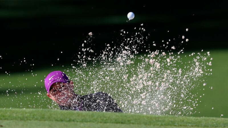 Rory McIlroy plays out of the bunker to the second green. Photo: Curtis Compton/Atlanta Journal-Constitution via AP