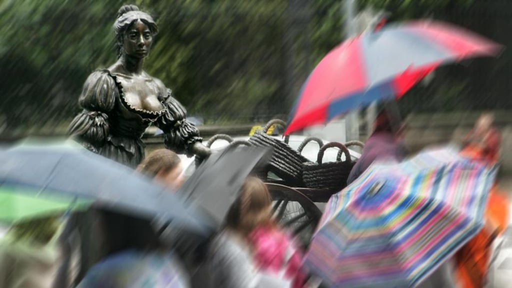Tourists take in the Molly Malone statue in College Green, Dublin.  Photograph by Matt Kavanagh/The Irish Times