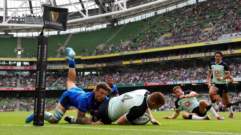 Andrew Conway  dives over to score Ireland’s third try as he is tackled by Matteo Minozzi of Italy  at the Aviva Stadium on Saturday. Photo by Dan Mullan/Getty Images)