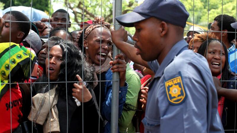 Crowds become agitated while waiting in line to view Nelson Mandela outside the Union Buildings in Pretoria. Photograph: Joao Silva/The New York Times