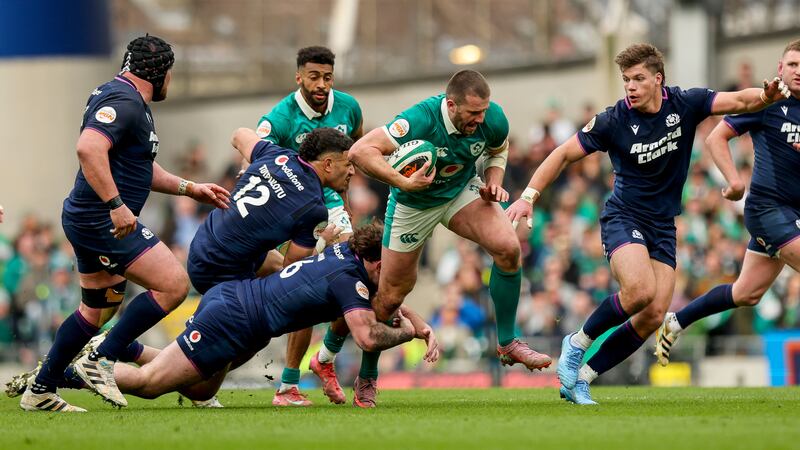 Stuart McCloskey evades Scotland's Sione Tuipulotu and Ewan Ashman. Photograph: Ryan Byrne/Inpho