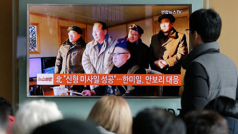 People  in Seoul, South Korea watch a TV news programme showing North Korean leader Kim Jong Un. Photograph: Ahn Young-joon/AP