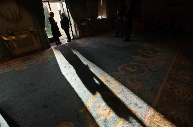 President Higgins and his wife Sabina pause briefly in the autumnal light before going in to meet guests. Photograph: Alan Betson