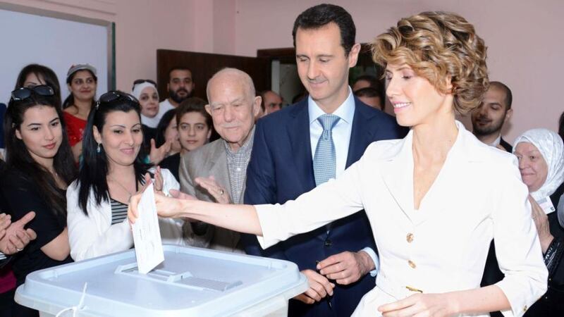 Bashar al-Assad and his wife Asma cast their votes during presidential elections at a polling station in Damascus. Photograph: Sana via Reuters