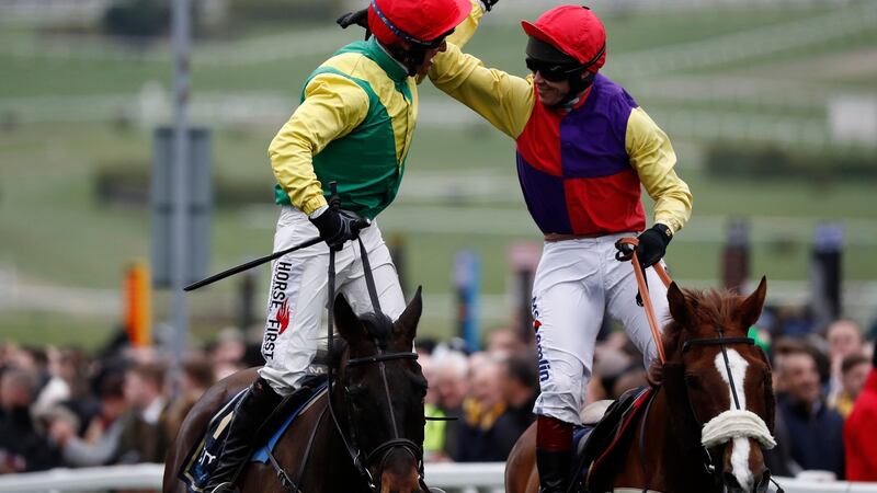 Robbie Power is congratulated by Richard Johnson after winning  Cheltenham Gold Cup Chase on Sizing John. Photograph: Stefan Wermuth/Reuters