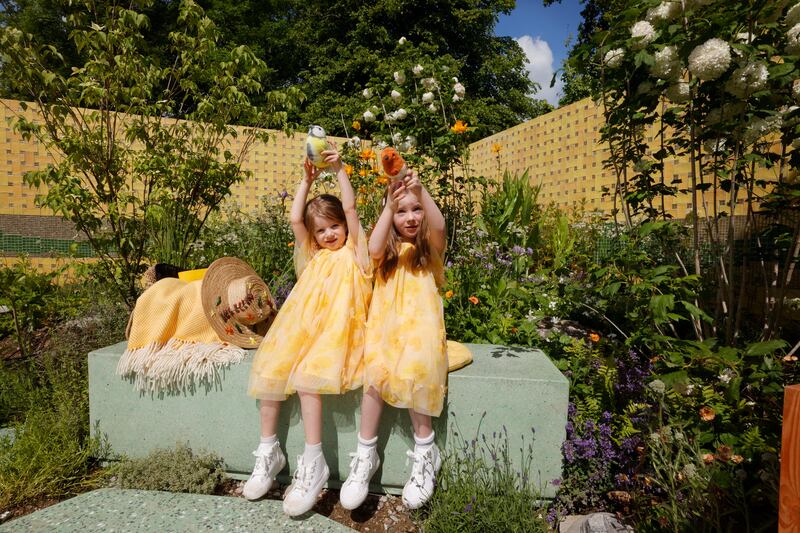 Martha (5) and Robyn (9) Lyons in the Kerrygold Nature Wrapped in Gold garden designed by Ailish Drake and Conor Hourigan. Photograph: Alan Betson/The Irish Times

