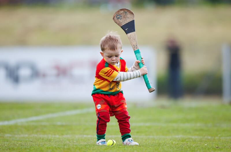Young Carlow fan Tommy Ryan practices a few pucks ahead of the game against Antrim at Corrigan Park. Photograph: Tom Maher/Inpho 