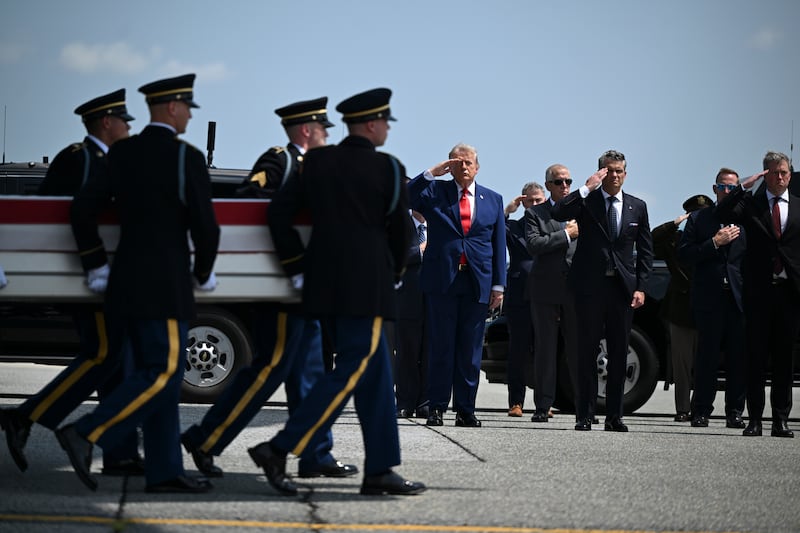 President Donald Trump and secretary of defence Pete Hegseth salute during a transfer for soldiers killed amid the conflict with Iran, at Dover Air Force Base in Delaware, on July 22nd, 2026. Photograph: Kenny Holston/The New York Times