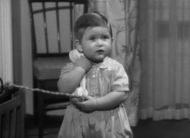 Charles as a toddler grappling with a telephone receiver in Charles R: The Making of a Monarch. Photograph: BBC/Royal Household