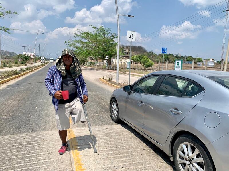 A one-legged man called Eri was holding out a plastic beaker in the hope drivers slowing down would drop money into it. Photograph: Peter Murtagh