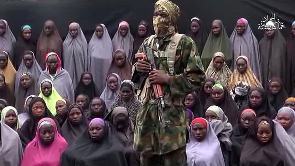 A video grab image created on August 14th, 2016. It allegedly shows a Boko Haram fighter standing in front of girls kidnapped from Chibok in April 2014.