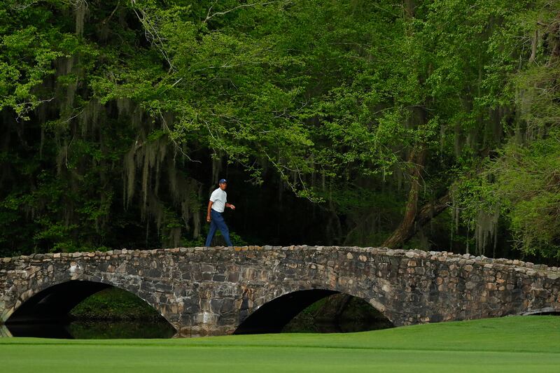 AUGUSTA, GEORGIA - APRIL 12: Tiger Woods of the United States walks across the Nelson bridge on the 13th hole during the second round of the Masters at Augusta National Golf Club on April 12, 2019 in Augusta, Georgia. (Photo by Kevin C. Cox/Getty Images)