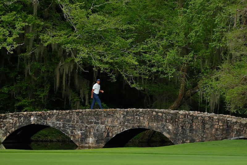 AUGUSTA, GEORGIA - APRIL 12: Tiger Woods of the United States walks across the Nelson bridge on the 13th hole during the second round of the Masters at Augusta National Golf Club on April 12, 2019 in Augusta, Georgia. (Photo by Kevin C. Cox/Getty Images)