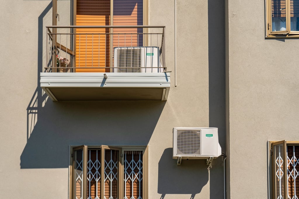 Air conditioning units on the facade of houses in Italy: global air conditioning demand will triple by 2050. Photographer: Francesca Volpi/Bloomberg