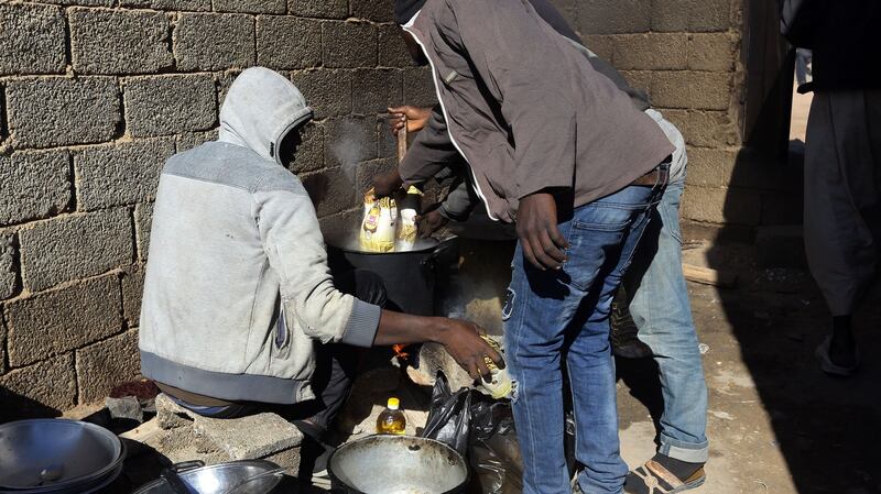 African migrants prepare food at a Safe House in the ‘ghost city’ of Bani Walid in 2017. Photograph: Mahmud Turkia/AFP via Getty Images