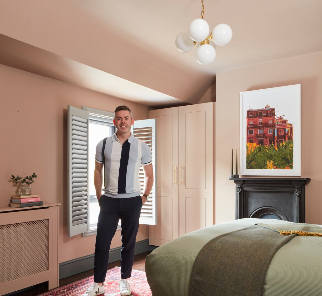 Darran Heaney in the master bedroom of his Phibsborough home, which underwent a dramatic makeover using the Dulux Heritage range. Pics: Philip Lauterbach
