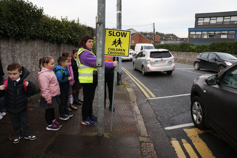 Sinead Egan helps children cross the road to attend St Patrick's National School in Chapelizod. Photograph: Bryan O’Brien/The Irish Times