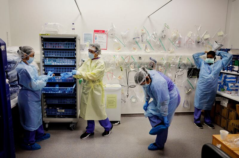 7.34pm: Medical staff don PPE in the clean zone before the start of a 12-hour shift. Photograph: Alan Betson