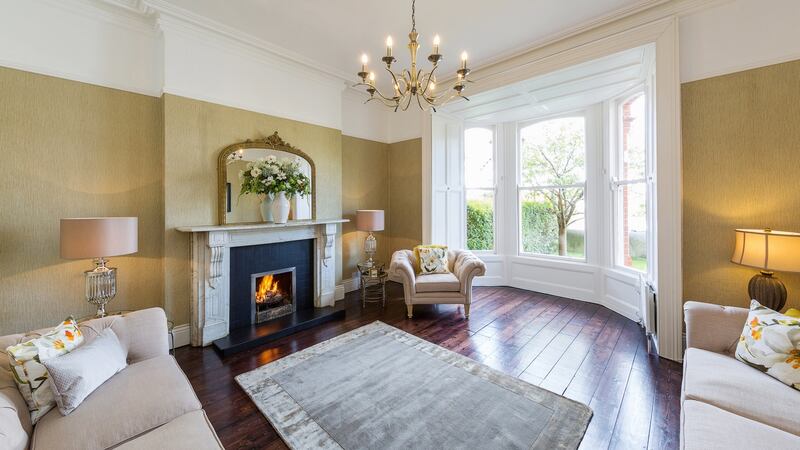 The drawingroom at  11 Spencer Villas has a wide and deep bay window with working shutters, a marble fireplace and original plasterwork