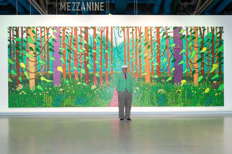 David Hockney with his work The Arrival of the Spring in Woldgate, East Yorkshire 2011. Photograph: Luc Castel/Getty