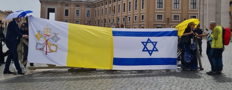 Tobias Wallbrecher, from the Let’s Remember Together group, was in St Peter's Square standing beside large Israeli and Vatican flags stitched together. Photograph: Patsy McGarry